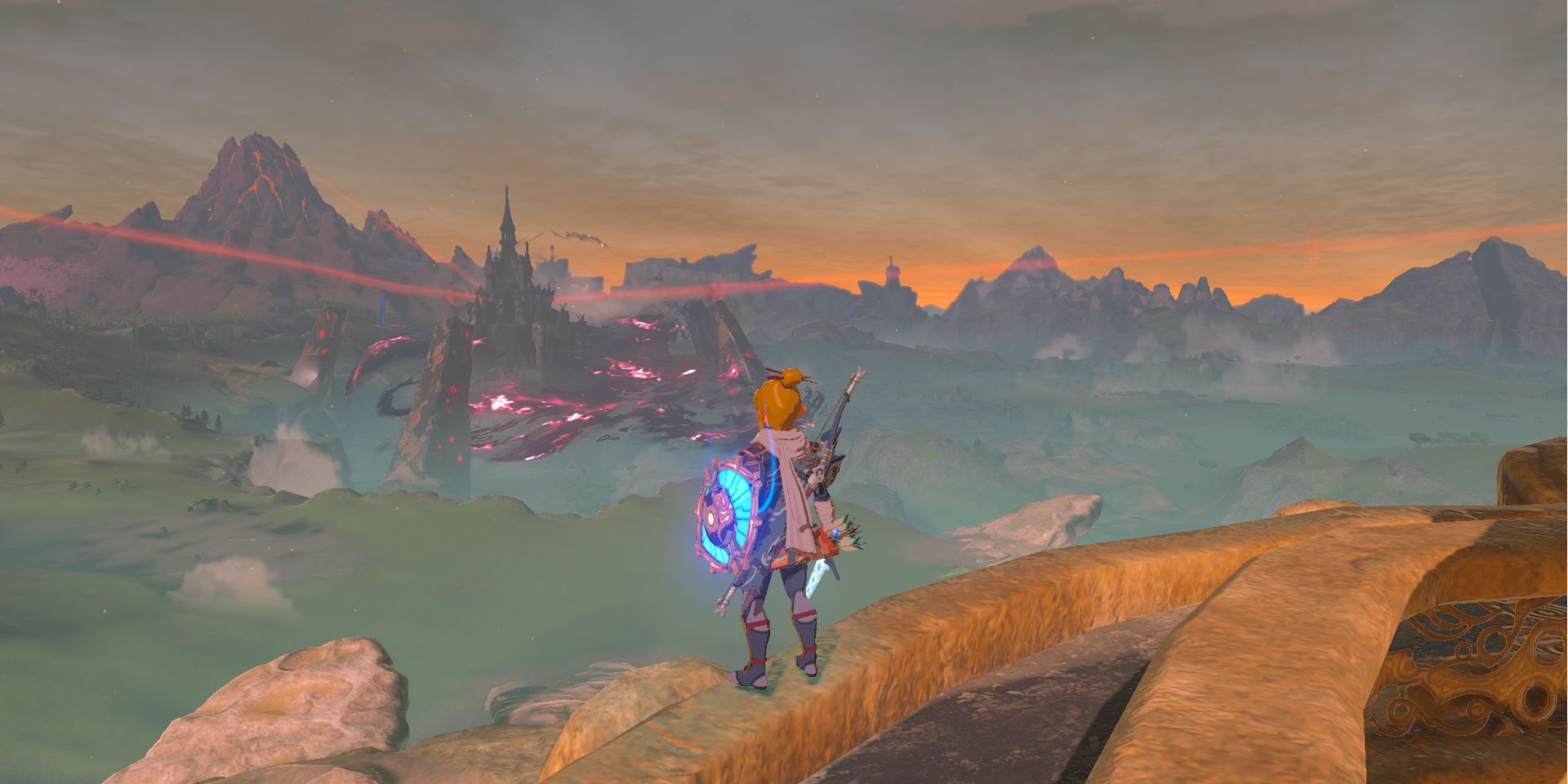 Screenshot of Breath of the Wild, featuring Link in Sheikah armor standing on a tower, looking towards Hyrule Castle.