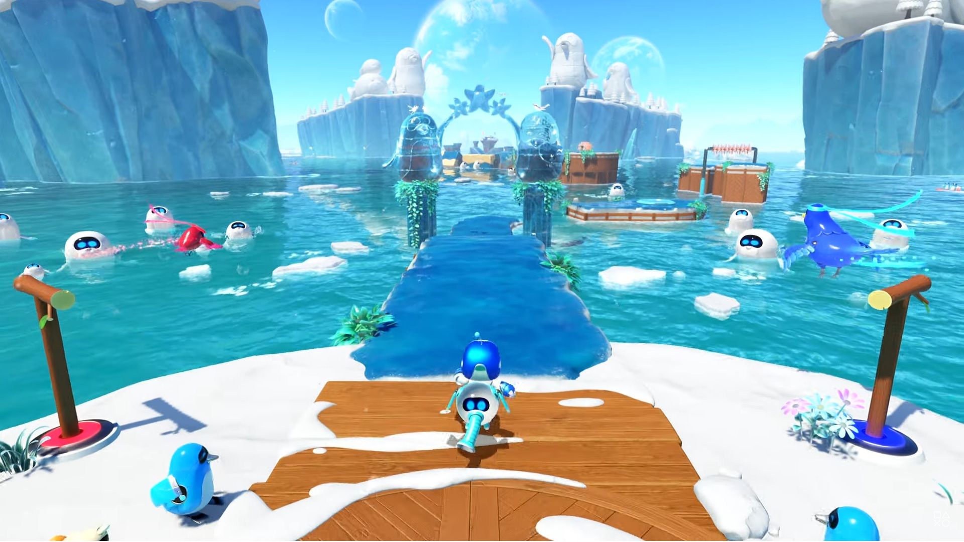 Astro Bot leaves the start of one of the five new Speed Run levels in the upcoming Astro Bot update on a wooden path, leaving behind penguins on a snowy island as he goes to a course that is hovering over water which has other bots and ice flow in it and flying off to the right is the bird he is racing