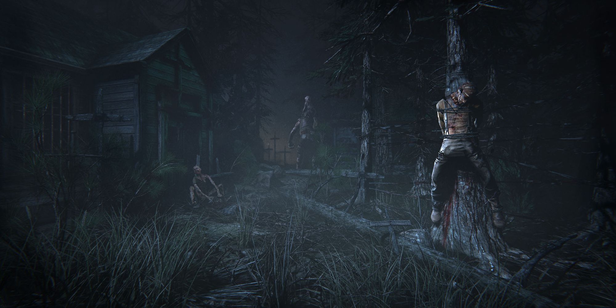 Dead body hanged to a tree in a forest with a cabin in the back in Outlast 2