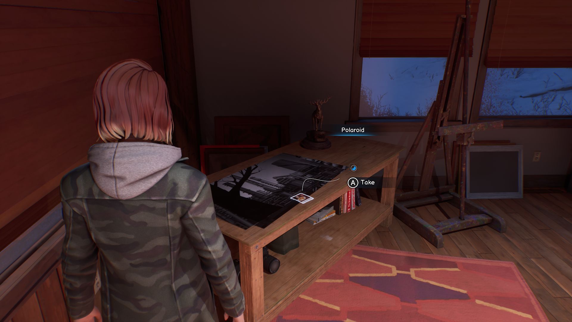 A screenshot with Max standing in front of the first Polaroid in Chapter 4, located on a table next to an easel, with several larger pictures below the photo.