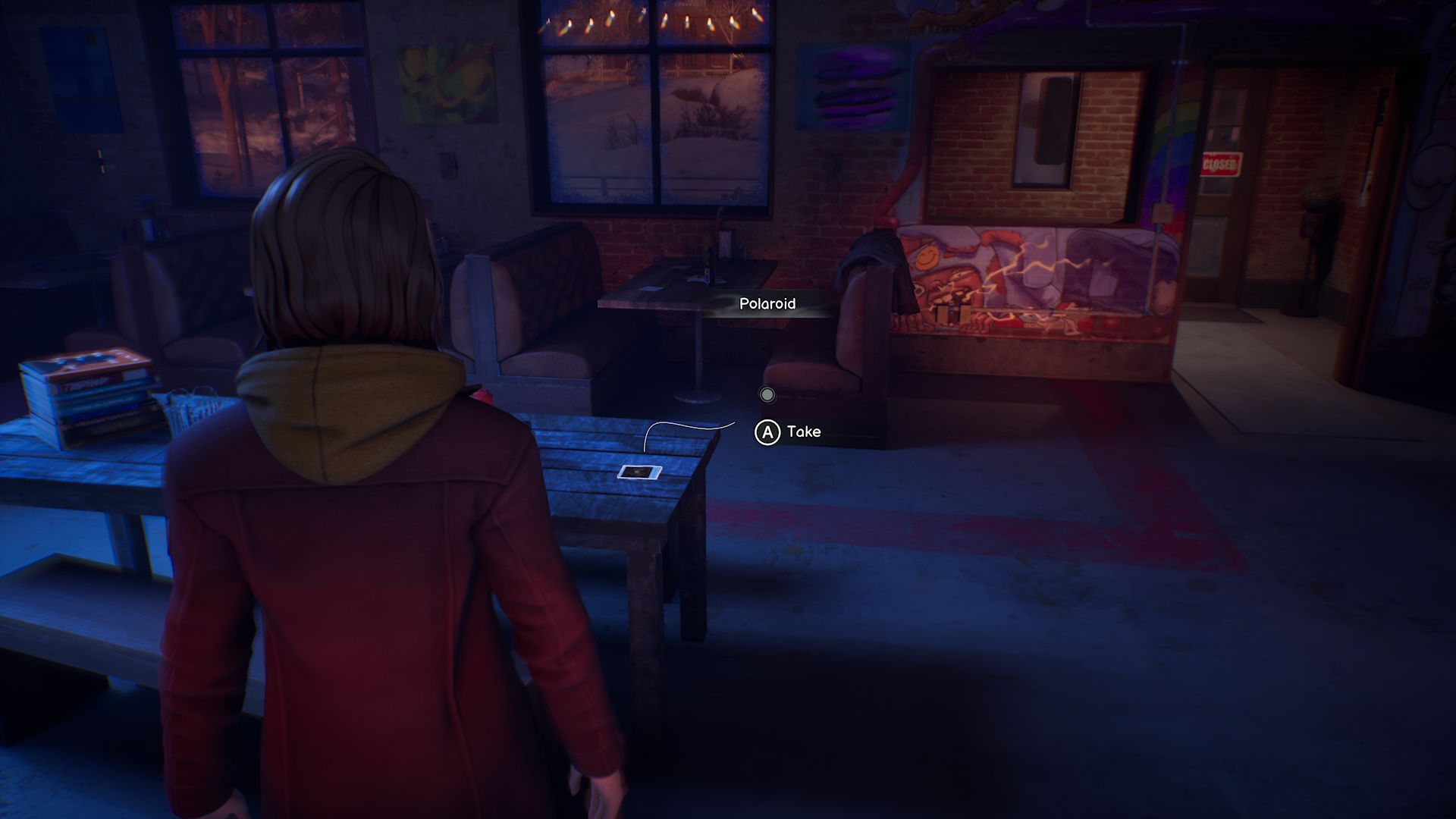 A screenshot with Max standing in front of the third Polaroid in Chapter 5, located on a rectangular table in the middle of a bar.