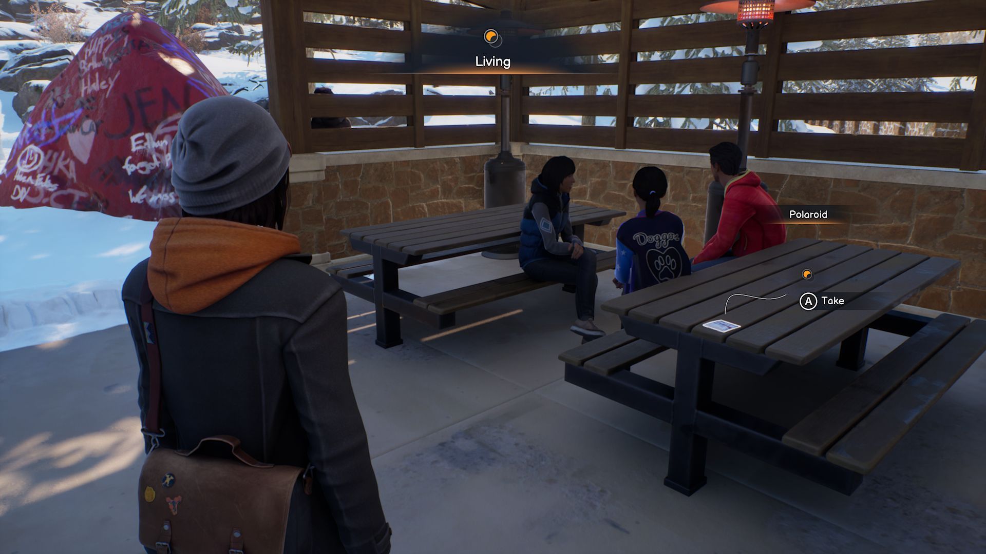 A screenshot with Max standing in front of the second Polaroid in Chapter 2, found on a picnic table in a rest area with three students nearby.