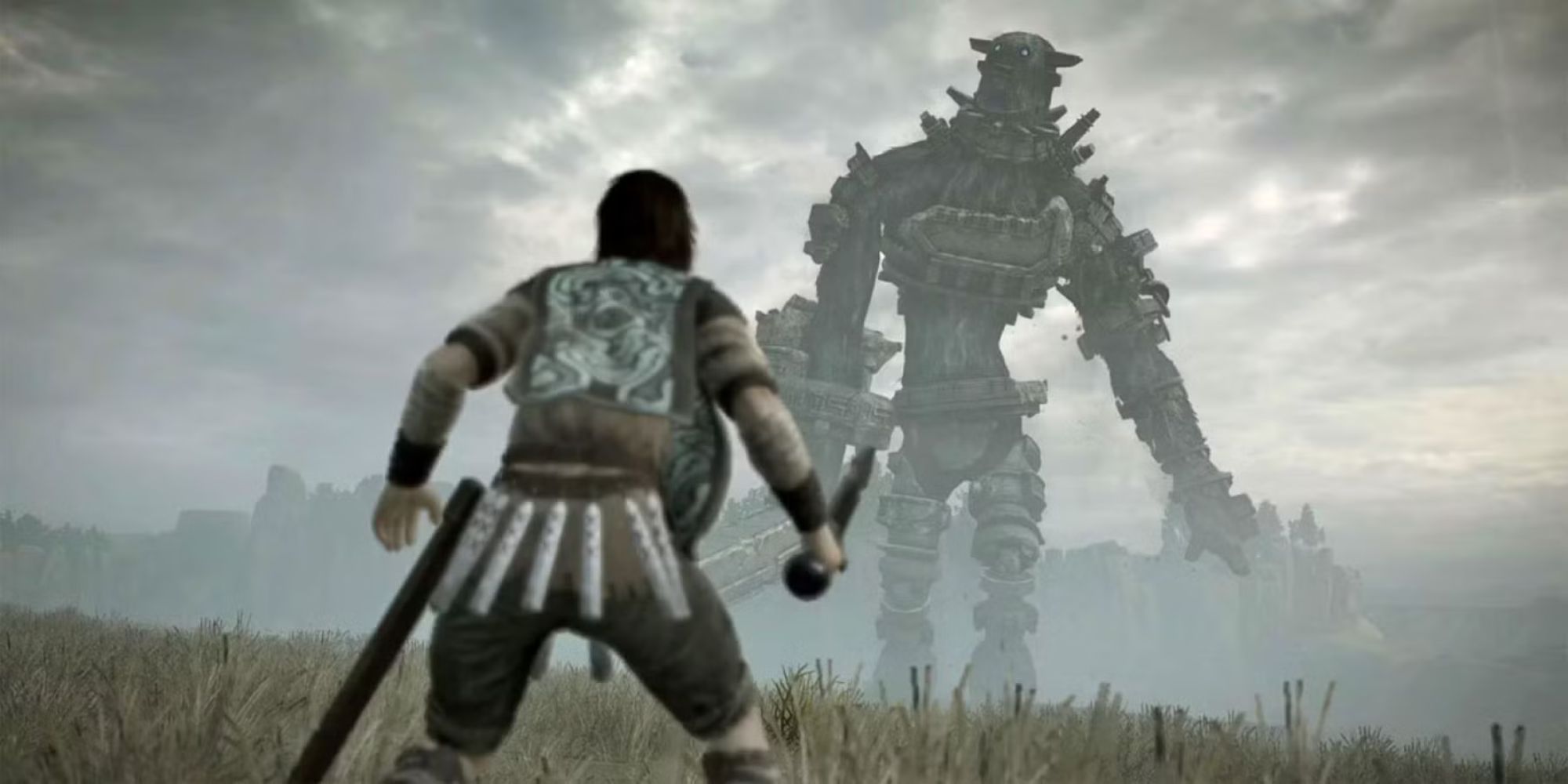 Wander standing in front of a Colossus in Shadow Of The Colossus