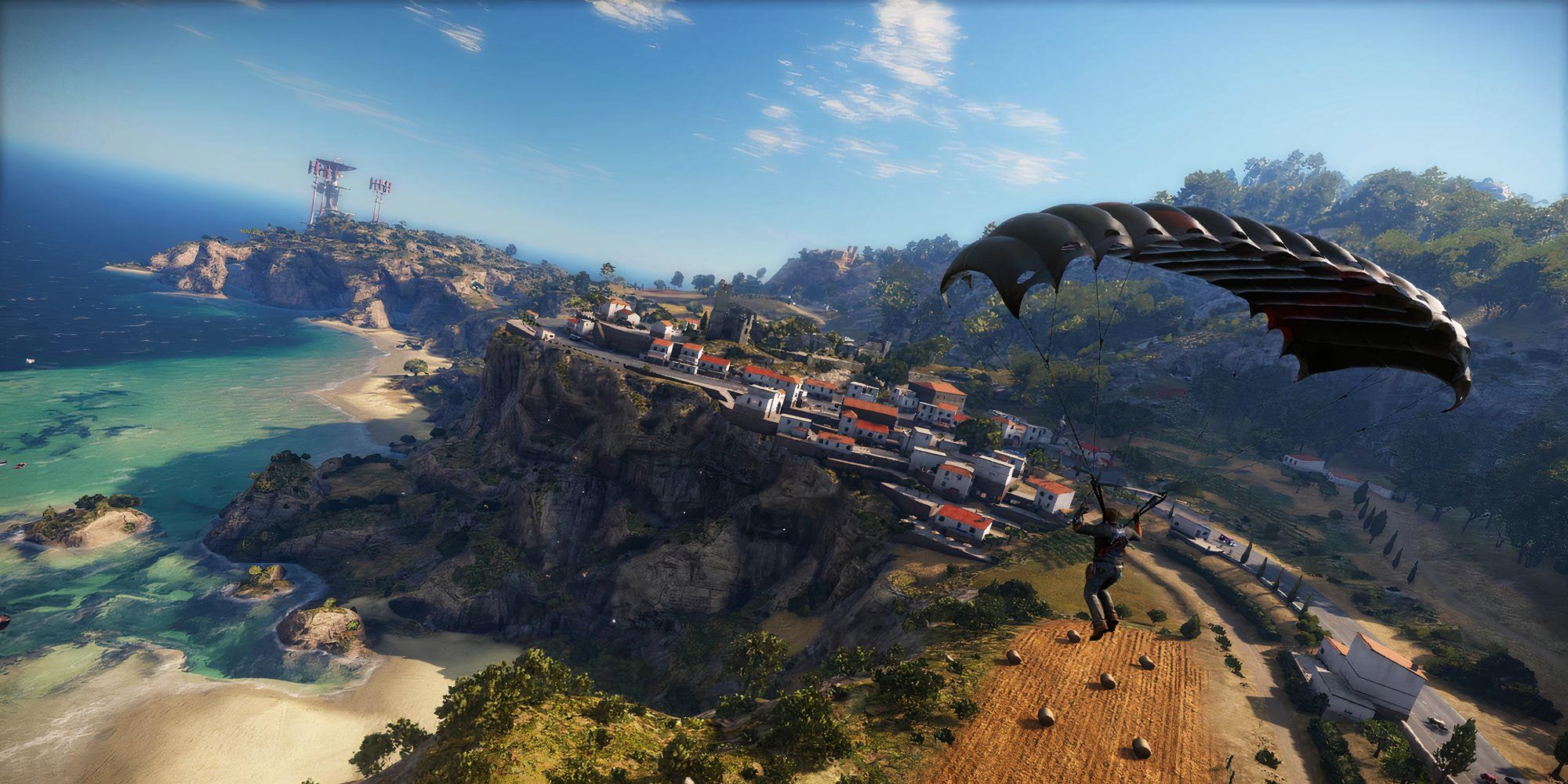 Rico paragliding over a town in Just Cause 3