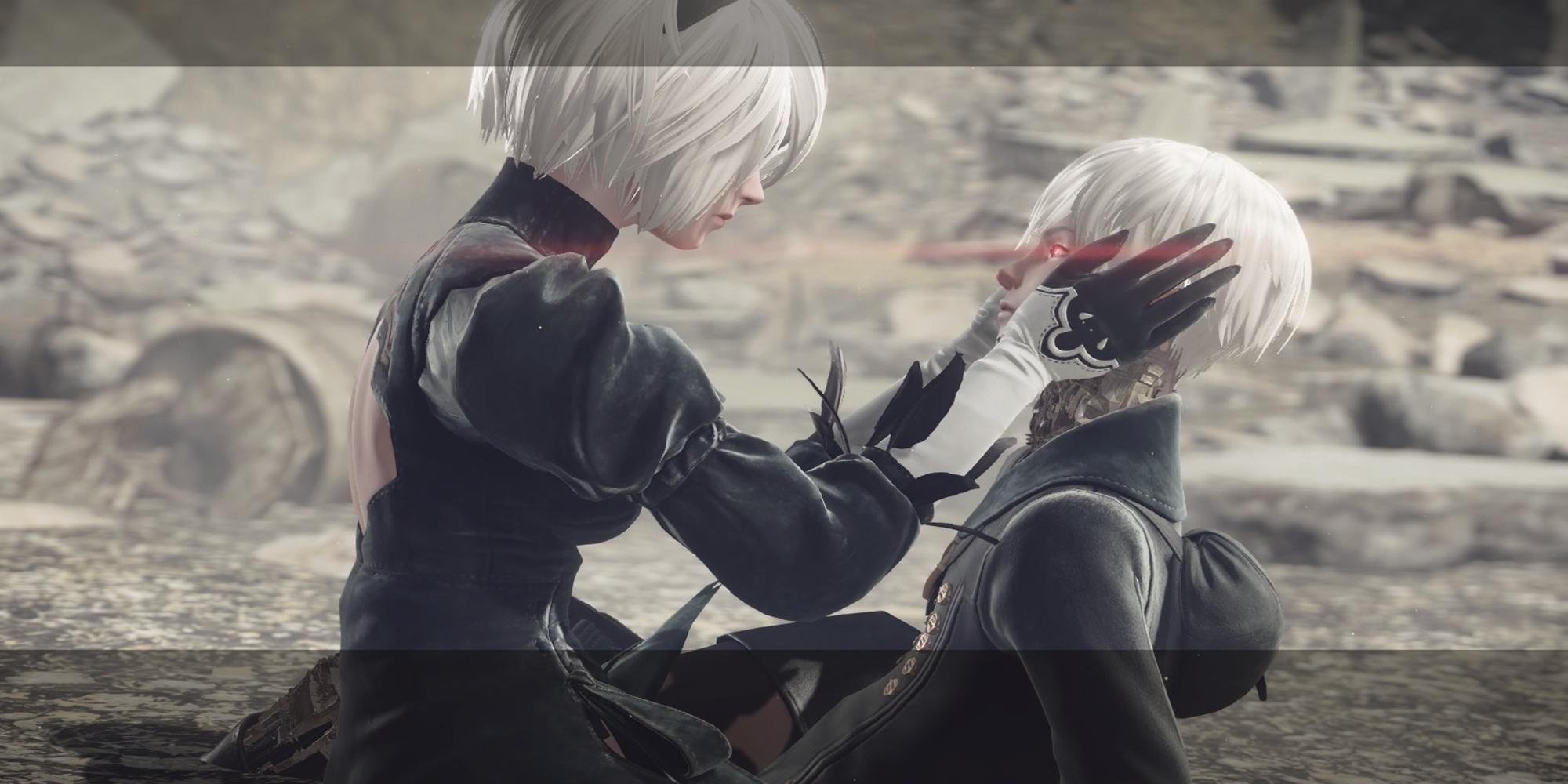 2B holding 9S face in her hands in Nier Automata